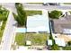 Aerial view of a single-Gathering home with a light blue driveway and overgrown yard at 3151 Wellington Dr, Holiday, FL 34691