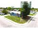 Aerial view of home with a neatly kept lawn, mature trees, in a quiet neighborhood setting at 3151 Wellington Dr, Holiday, FL 34691