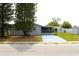 Home featuring a fenced backyard, mature trees, a screened in patio, and a peaceful setting at 3151 Wellington Dr, Holiday, FL 34691