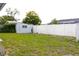 Expansive backyard presents a utility shed and a fence, offering privacy and storage solutions at 3151 Wellington Dr, Holiday, FL 34691