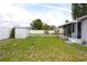 Large backyard with utility shed; great for recreation, pets, and screened patio access at 3151 Wellington Dr, Holiday, FL 34691