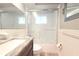 Modern bathroom with a wood vanity, stone countertop, and a glass-enclosed shower at 3151 Wellington Dr, Holiday, FL 34691