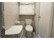 Functional bathroom with a toilet, cabinet, and towel holder, designed for practical use at 3151 Wellington Dr, Holiday, FL 34691