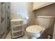 Compact bathroom features a standard toilet, small storage unit, and tiled walls for easy cleaning at 3151 Wellington Dr, Holiday, FL 34691