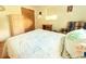 Well-lit bedroom with hardwood floors, a bed with white patterned bedding and lots of natural light at 3151 Wellington Dr, Holiday, FL 34691