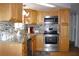 Well-lit kitchen with granite countertops, modern appliances, and mosaic backsplash at 3151 Wellington Dr, Holiday, FL 34691