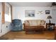 Cozy living room with comfortable seating, hardwood floors, and natural light from a window at 3151 Wellington Dr, Holiday, FL 34691