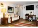 Inviting living room with hardwood floors, a comfortable couch, a flat screen TV, and cozy decor at 3151 Wellington Dr, Holiday, FL 34691