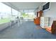 Screened patio includes furniture and storage shelves, offering an enclosed outdoor living space at 3151 Wellington Dr, Holiday, FL 34691