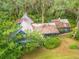 Aerial view of the home showcasing the roofline, landscaping, and surrounding trees at 3270 Endsley Rd, Brooksville, FL 34604