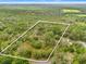 Aerial view of the property, highlighting the treed acreage at 3270 Endsley Rd, Brooksville, FL 34604