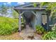 Inviting side porch with rocking chairs, potted plants, and stone pathway at 3270 Endsley Rd, Brooksville, FL 34604