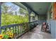 Relaxing side porch with wooden railings, potted plants, and rocking chairs at 3270 Endsley Rd, Brooksville, FL 34604