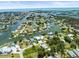 Panoramic aerial view of a coastal community with homes situated on a network of waterways at 4104 Pine Dale Ct, Hernando Beach, FL 34607