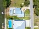 High-angle aerial view of two homes with pools and a boat dock, presenting a luxurious waterfront lifestyle at 4104 Pine Dale Ct, Hernando Beach, FL 34607