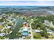 Aerial view of canal front home with a pool and dock, offering direct access to open water at 4104 Pine Dale Ct, Hernando Beach, FL 34607