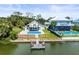 Breathtaking aerial view of waterfront homes each with a pool and boat dock, illustrating luxurious coastal lifestyle at 4104 Pine Dale Ct, Hernando Beach, FL 34607