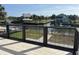 Picturesque view of a tranquil backyard with a canal, dock, and lush greenery from the private patio at 4104 Pine Dale Ct, Hernando Beach, FL 34607