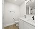 Modern bathroom boasts double sinks, marble countertops, stylish black hardware and a glass-enclosed shower at 4104 Pine Dale Ct, Hernando Beach, FL 34607