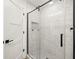 Modern glass shower enclosure with stylish tile work and sleek black hardware at 4104 Pine Dale Ct, Hernando Beach, FL 34607