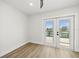 Bedroom with a lakeside view through a double door to the outside at 4104 Pine Dale Ct, Hernando Beach, FL 34607