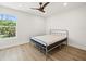Bedroom with a window view and light plank flooring at 4104 Pine Dale Ct, Hernando Beach, FL 34607