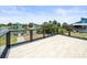 Waterfront deck featuring wood railing and beautiful water views at 4104 Pine Dale Ct, Hernando Beach, FL 34607