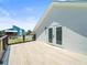 View of deck with light wood tile and doors leading inside at 4104 Pine Dale Ct, Hernando Beach, FL 34607