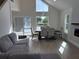 Bright dining area featuring a large window, elegant dining table, and sliding glass doors to the pool at 4104 Pine Dale Ct, Hernando Beach, FL 34607