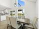 Dining area featuring a table set for six, next to the kitchen, with pool views at 4104 Pine Dale Ct, Hernando Beach, FL 34607