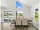 Dining area with large windows offering pool views, highlighted by a modern pendant light at 4104 Pine Dale Ct, Hernando Beach, FL 34607