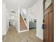 Open entryway with hardwood stairs, tile flooring, and views to kitchen and living room at 4104 Pine Dale Ct, Hernando Beach, FL 34607