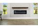 Close-up of a modern electric fireplace with a white marble surround and wood mantle at 4104 Pine Dale Ct, Hernando Beach, FL 34607