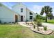 Beautiful two story home with white facade, modern windows, manicured lawn and inviting walkway at 4104 Pine Dale Ct, Hernando Beach, FL 34607