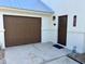Charming home exterior featuring a brown garage door and a cozy front entrance with stylish accents at 4104 Pine Dale Ct, Hernando Beach, FL 34607