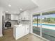 Modern kitchen with white cabinetry, stainless steel appliances, and a view of the pool at 4104 Pine Dale Ct, Hernando Beach, FL 34607