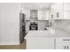 Bright kitchen features white cabinets, stainless steel appliances, and marble countertops at 4104 Pine Dale Ct, Hernando Beach, FL 34607