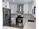 Modern kitchen with sleek white cabinetry, stainless steel appliances, and stylish countertops for a contemporary look at 4104 Pine Dale Ct, Hernando Beach, FL 34607