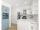Stylish kitchen with white cabinets, stainless appliances, and complementary blue accents at 4104 Pine Dale Ct, Hernando Beach, FL 34607