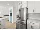 Open kitchen design boasts stainless steel refrigerator and provides open access to the living area at 4104 Pine Dale Ct, Hernando Beach, FL 34607