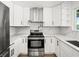 Bright kitchen featuring stainless steel appliances, white cabinets, stylish hardware, and sleek marble countertops at 4104 Pine Dale Ct, Hernando Beach, FL 34607