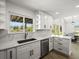 Bright kitchen with stylish white cabinets, marble countertops, and a water view at 4104 Pine Dale Ct, Hernando Beach, FL 34607