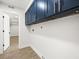Laundry room with blue cabinets and light plank flooring at 4104 Pine Dale Ct, Hernando Beach, FL 34607