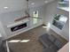 Bright living room with fireplace and accent wall, ceiling fan, modern gray couch and hardwood floors at 4104 Pine Dale Ct, Hernando Beach, FL 34607