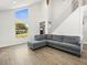 Bright living room with tile floors, large windows, and view of modern stairwell at 4104 Pine Dale Ct, Hernando Beach, FL 34607