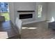 Bright living area featuring a cozy fireplace, large window, and stylish decor perfect for relaxation at 4104 Pine Dale Ct, Hernando Beach, FL 34607