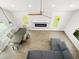 Aerial view of living room with modern fireplace, dining, and sitting area at 4104 Pine Dale Ct, Hernando Beach, FL 34607
