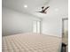 Bright and spacious main bedroom features a ceiling fan, wood-look flooring and sliding glass doors to the yard at 4104 Pine Dale Ct, Hernando Beach, FL 34607