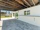 Covered patio with stone tile flooring and white walls at 4104 Pine Dale Ct, Hernando Beach, FL 34607