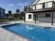 Inviting backyard pool area with stone pavers and second story deck, perfect for relaxation and summer fun at 4104 Pine Dale Ct, Hernando Beach, FL 34607